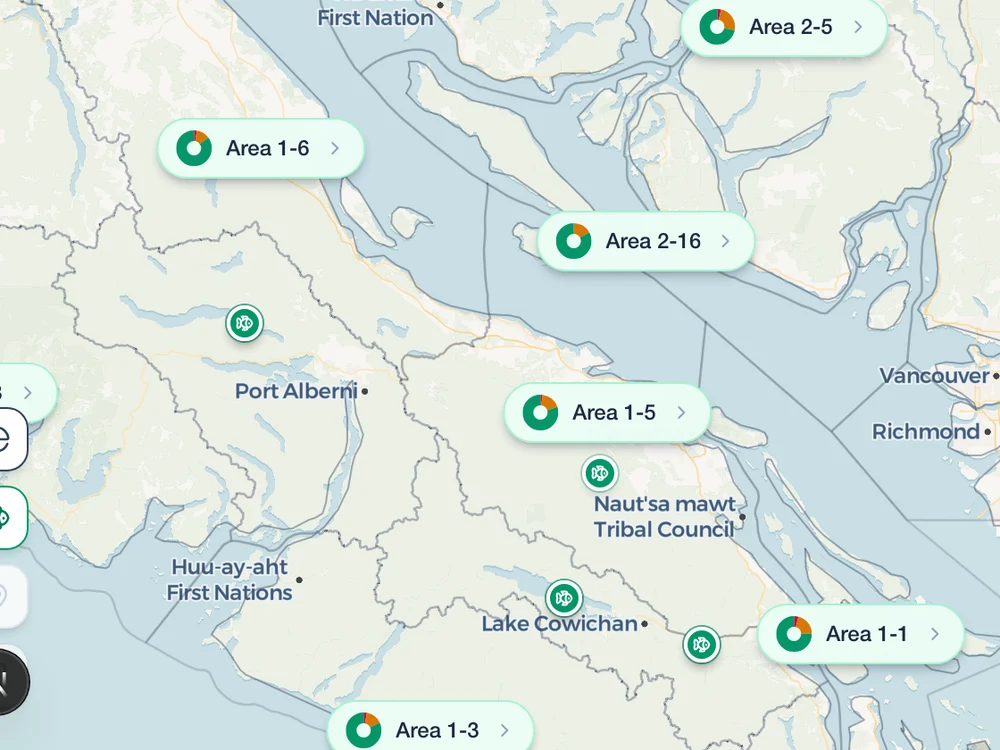 The map over central Vancouver Island with catch markers pinned at Stamp River, Cowichan Lake and two more waters, among the fishing-area badges